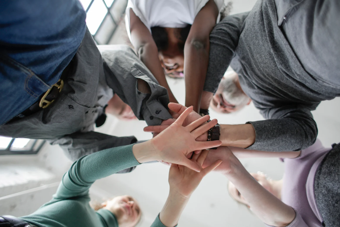 Hands coming together representing resilience in a team