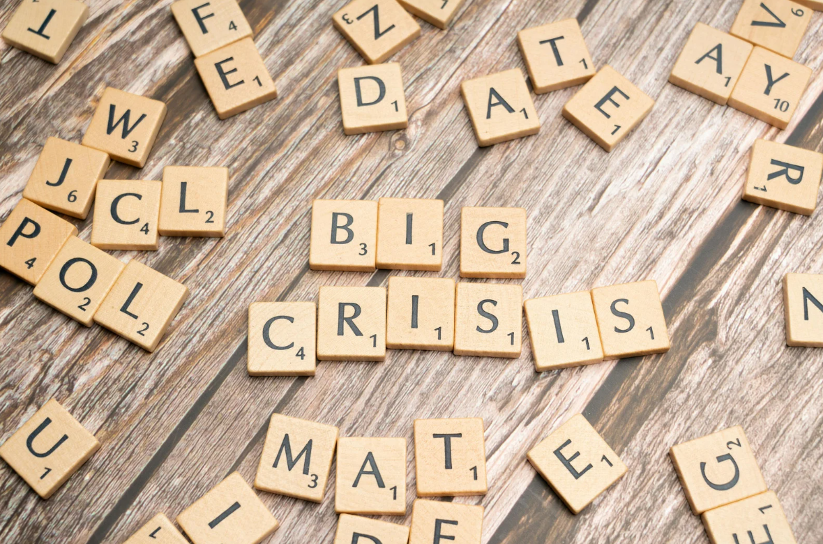 Scrabble letters spelling out 'big crisis'
